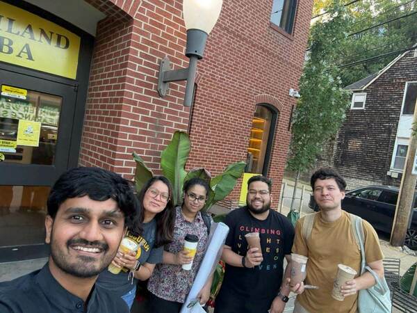 Puja Chakraborty standing with Dr. Gomes and other members of the Gomes lab